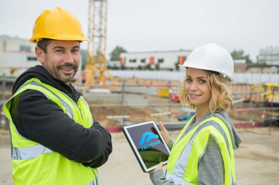 Construction_Team holding tablet with Nimbus Mobile Application on the screen
