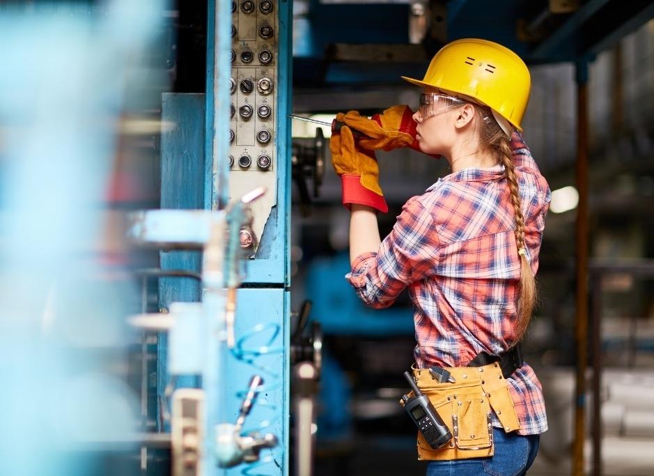 job Management Female tradesperson working on a building